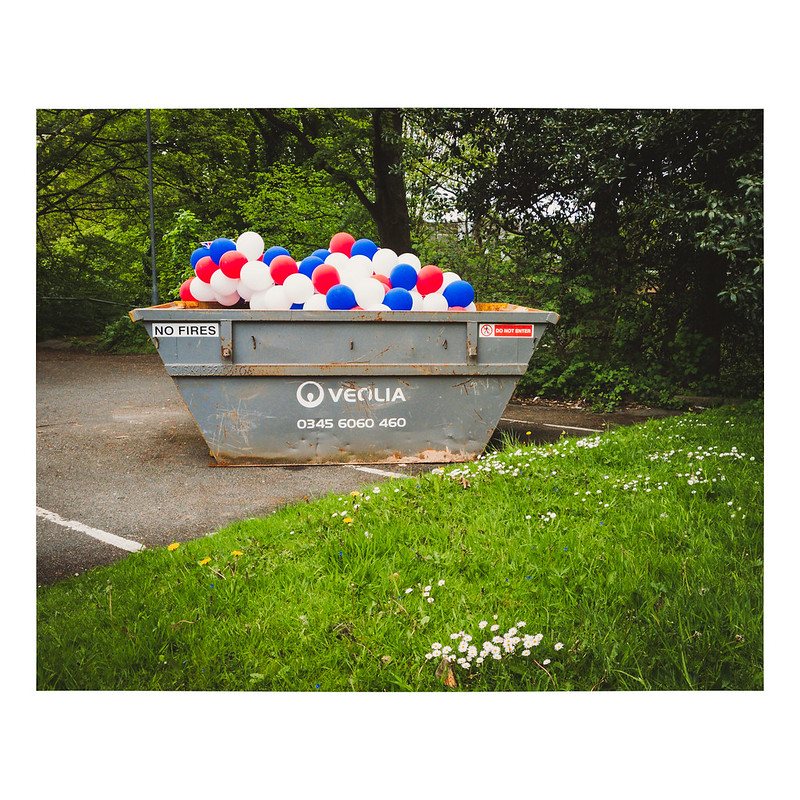 A skip filled with red, white, and blue balloons following celebrations for the coronation of King Charles III